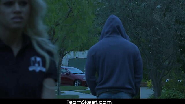 Jessa Rhodes in polo shirt eyes hooded guy lurking by car after class