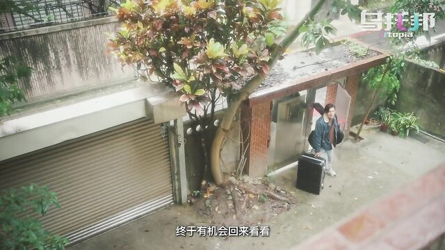 Japanese girl with suitcase at outdoor entrance in steamy JAV movie