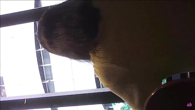 Spy cam of busty Asian woman in yellow mesh top at restaurant toilet