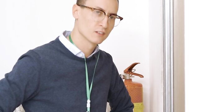 Cherry Candle in tight sweater, lanyard by fire extinguisher at college event