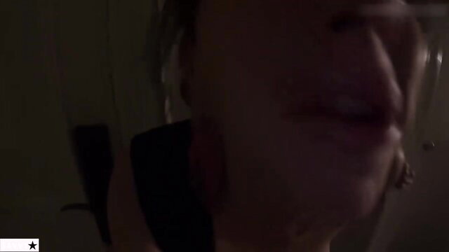 Closeup of mature blonde MILF's plump lips in dim hotel light