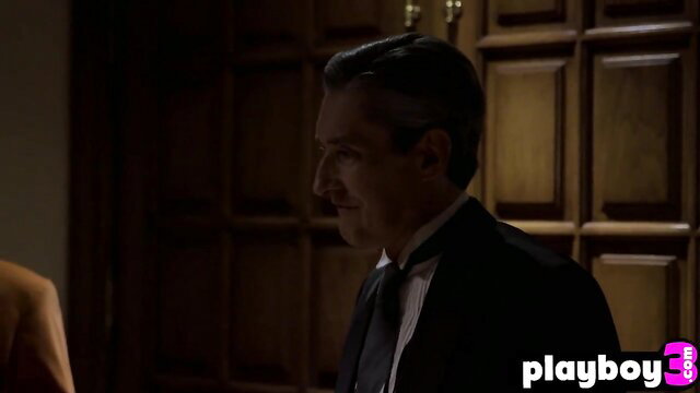 Suited mature man in dimly lit room, raunchy crime-solving babe scene