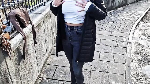 Hot babe flashing erect nipples in white crop top and tight jeans outdoors