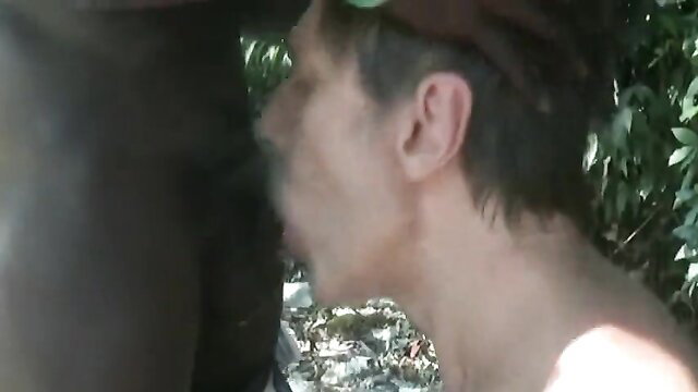 Black man facefucks white guy outdoors, urine and cum in mouth closeup