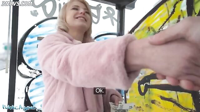 Short hair blonde teen in pink fur coat shakes hand at bus stop pickup
