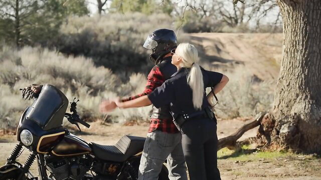 Busty police MILF Bridgette B with biker by motorcycle