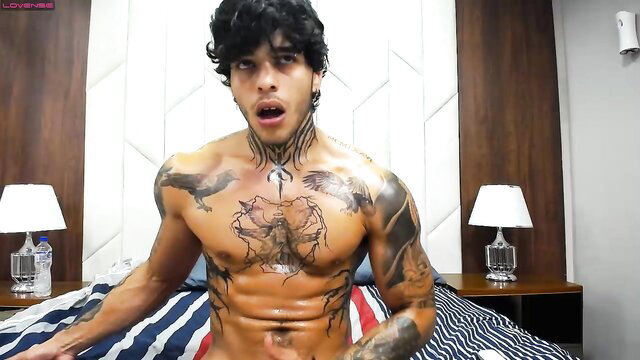 Tattooed Latino twink Ray Coopers masturbating shirtless on bed