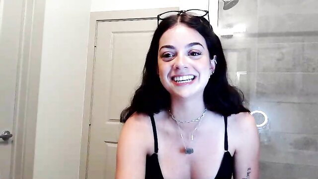 Luxxbaddie smiling in black tank top, big tits, bathroom selfie