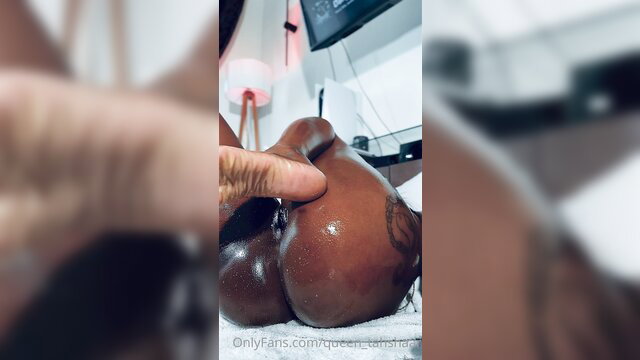 Closeup of thick black woman's oiled big ass grabbed by hand