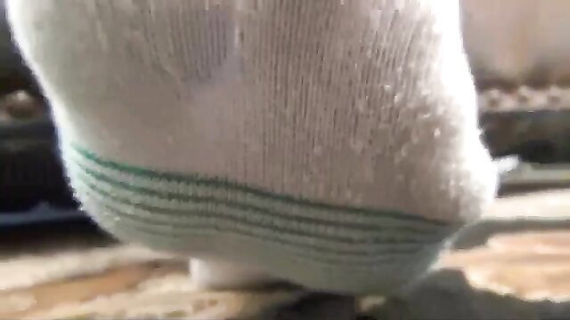 Giantess white crew socks with green stripes on foot sole, fetish closeup