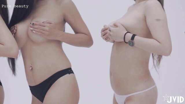 Two nude Asian beauties posing topless in panties, slim bodies