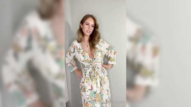 Blonde woman in floral kimono dress, teasing open robe pose