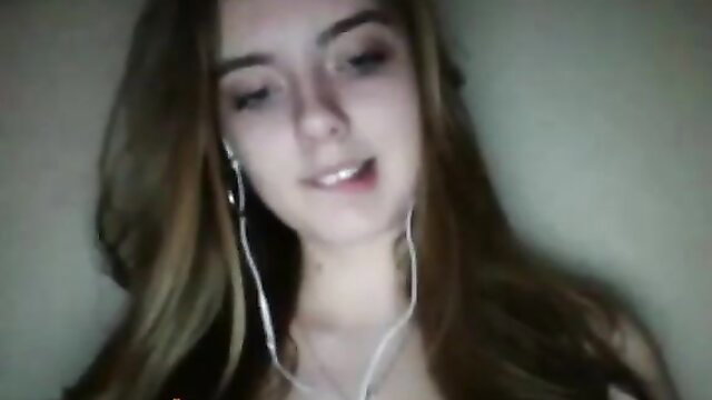 Cute amateur Omegle teen girl with headphones smiling closeup