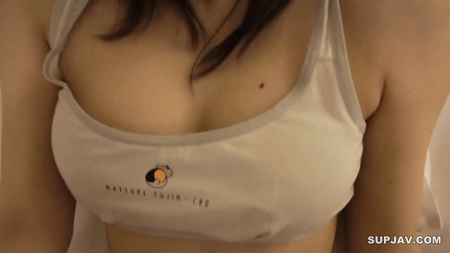 Asian beauty in tight white sports bra showing deep cleavage closeup