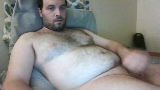 Hairy plump bear fingering himself solo on bed