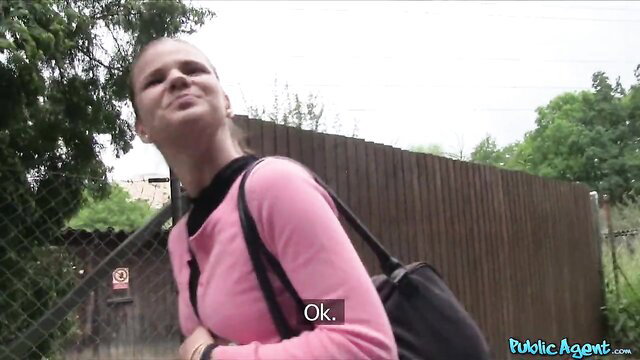 Sarah Kay smirking in pink sweater outdoors Public Agent quickie