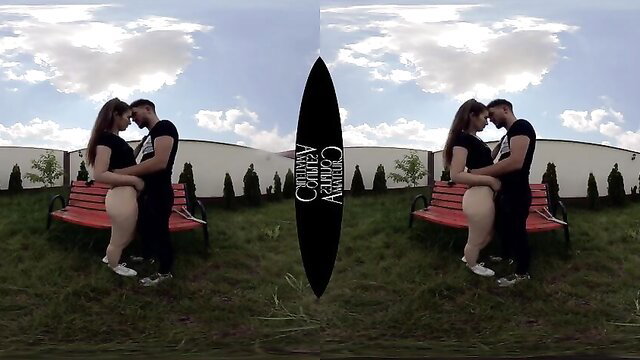 Teen amateur couple kissing intimately on red bench in VR outdoor scene