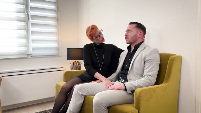 Foxy redhead in stockings seduces suited man on couch in therapy sex