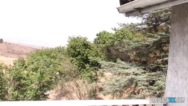 Brunette milf Bianca Breeze outdoor patio view, lush greenery backdrop