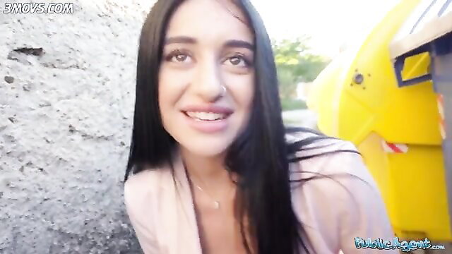 Ara Mix posing next to a yellow vehicle