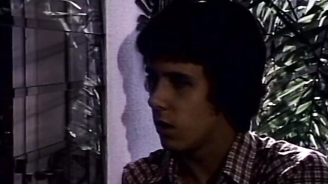 Young man in plaid shirt, intense stare from 1983 Tomboy uncut classic