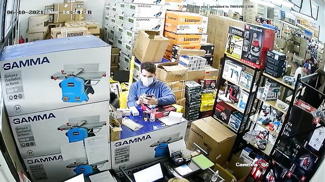 Masked man working in warehouse stock room afternoon shift