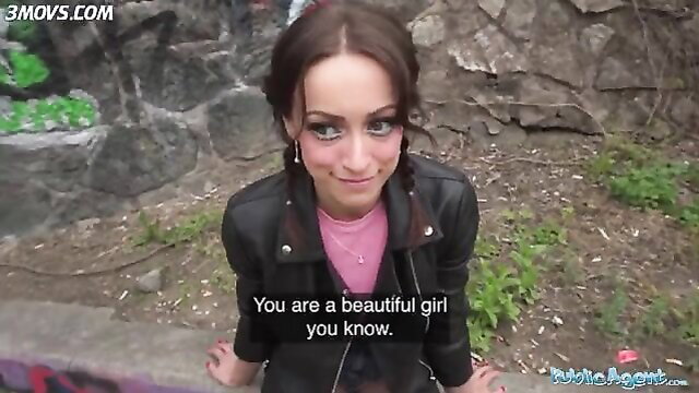 Beautiful brunette in leather jacket squats outdoors, public tease