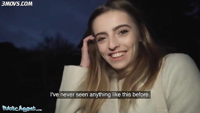 Alba Lala smiling on dark street, showing small tits outdoors