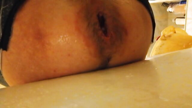 Closeup of woman's gaping asshole after dildo ass play, wet and stretched