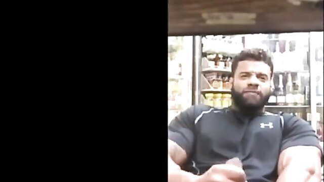 Muscular Arab hunk stroking huge cock in store gay cumshot tease