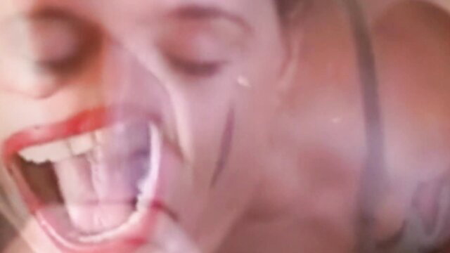 Blonde woman screaming with open mouth in intense fetish closeup