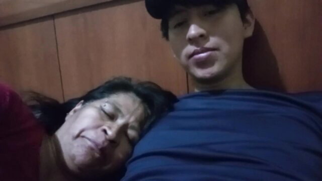 Asian son-in-law cuddles busty mature cougar in-law on bed