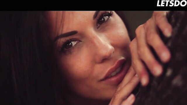 Alexa Tomas closeup seductive gaze and hands gripping in forest tease