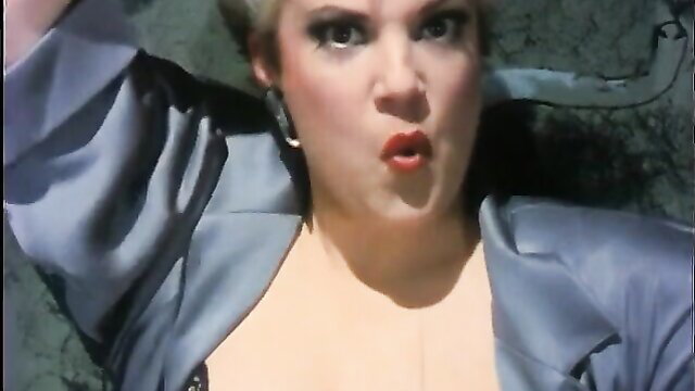 Blonde bombshell in open blouse, intense expression in classic 80s porn