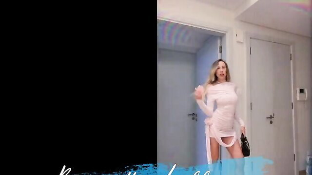 Blonde in sheer white dress dances sexy in bedroom mirror selfie