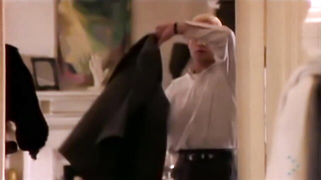 Blond man in white shirt checking black suit in mirror, Belouis Some Imagination