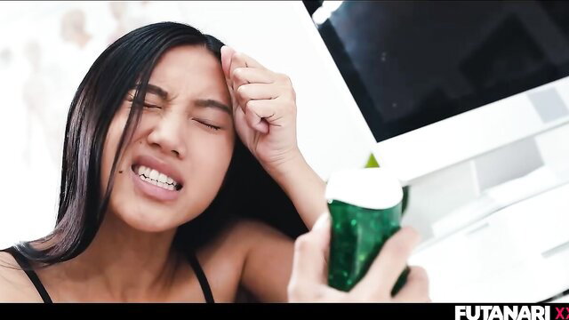 May Thai grimacing in ecstasy holding green can, topless tease