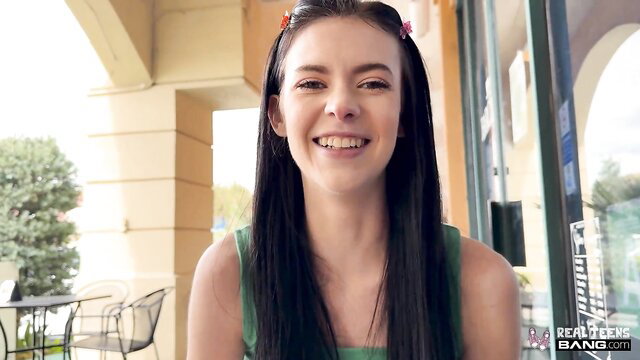 Brunette teen Ella Nova smiles in green tank top outdoors POV