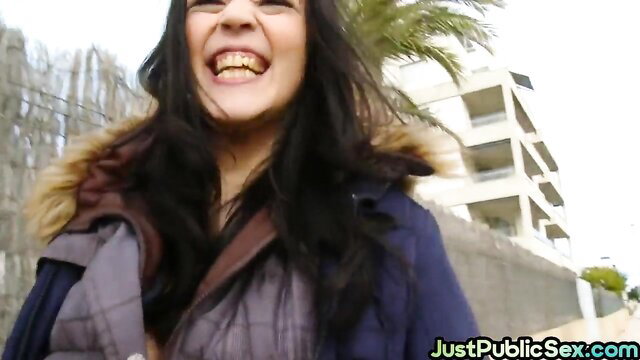 Smiling Latina in coat flashes tits outdoors public tease