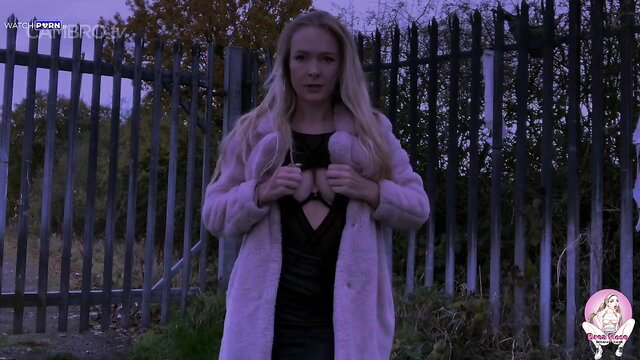 Brea Rose in pink fur coat and black dress at bukkake fence