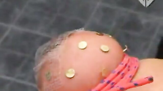 Torture Galaxy woman with gold pins in shaved breast, bound pink rope