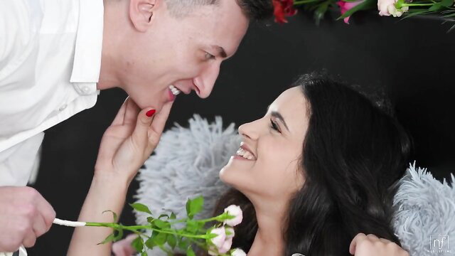 Melody Marks smiles passionately with man in romantic flower tease