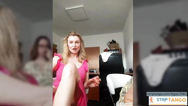 Blonde bombshell in pink dress teases legs in live cam chat