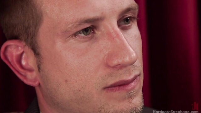 Closeup of handsome young man's aroused face in hardcore scene