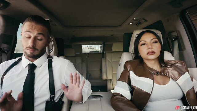 Asian beauty in white top and leather jacket with suited man in luxury SUV