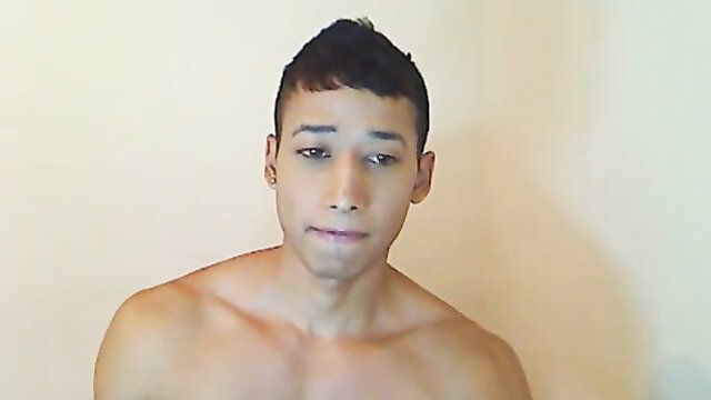 Hot Latino camboy shirtless closeup, toned chest and sultry gaze