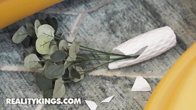 Kira Noir with eucalyptus flowers next to broken white vase on floor