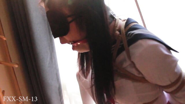 Blindfolded Asian JK girl in ropes, single leg suspension, drooling tears closeup