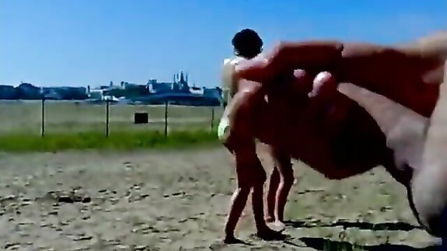 Topless woman fingered by hand on sunny beach outdoors