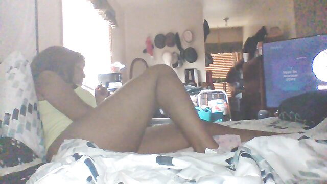 Hot black amateur babe in yellow top lounging sexy on bed